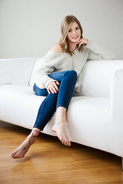 istock Beautiful young woman posing on sofa 497742458