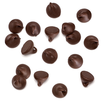 Chocolate morsels on white background from top