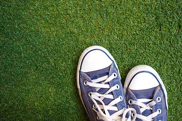 istock Blue sneaker shoes on grass. Top view. Vintage effect. 497742960