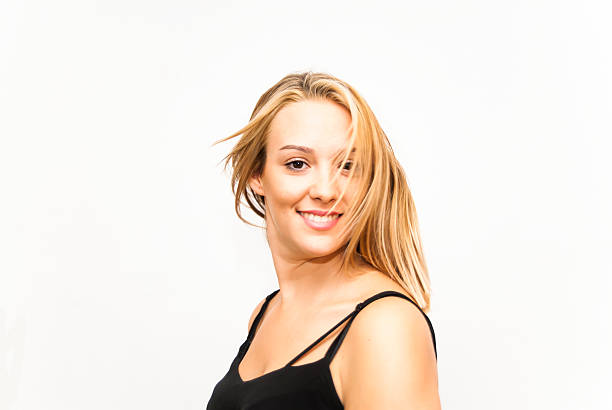 Young woman wearing turtleneck jumper against white background,portrait,smiling,close up