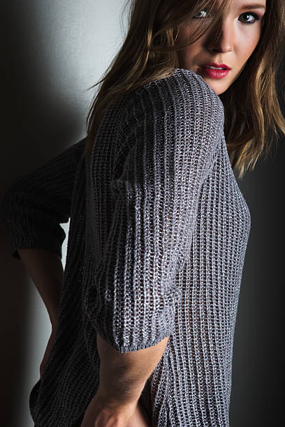 istock Sensual young woman posing in gray sweater 497744888