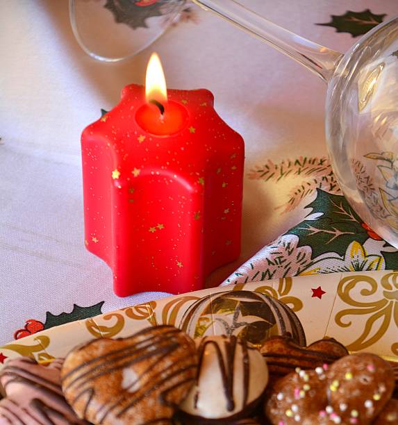 istock Christmas decorated gingerbread cookies on the table with lighted candle 497746280