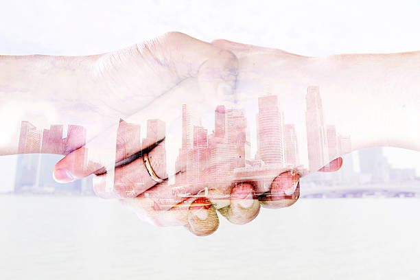 istock Double exposure of Handshake and a city background 497746780