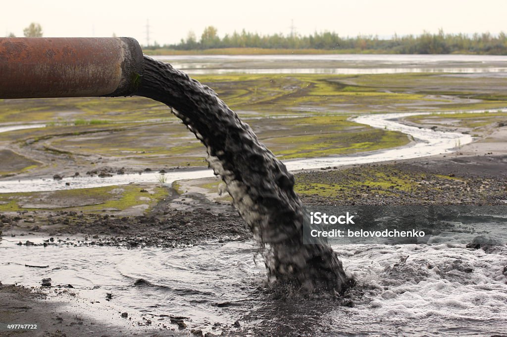 Industrial pipe discharging liquid waste Water Pollution Stock Photo