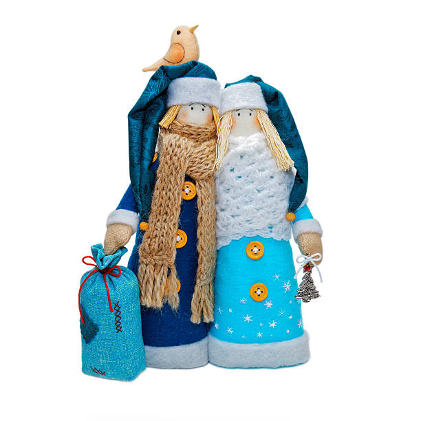Two Handmade Christmas toys. Russian Ded Moroz and Snow-maiden in blue costume and hats. Isolated on white.