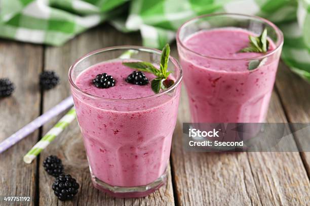 Blackberry Smoothie In The Glasses On Grey Wooden Background Stock Photo - Download Image Now