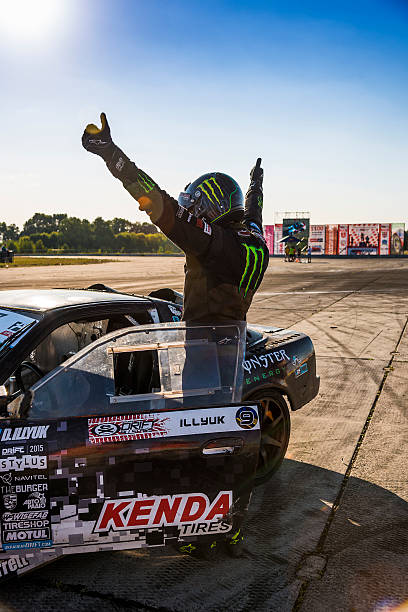 Racer Dmytro Illyuk welcomes visitors  Vinnytsia,Ukraine-July 25, 2015:  Racer Dmytro Illyuk welcomes visitors near the track in the Drift championship of Ukraine on July 25,2015 in Vinnytsia, Ukraine. monster energy stock pictures, royalty-free photos & images