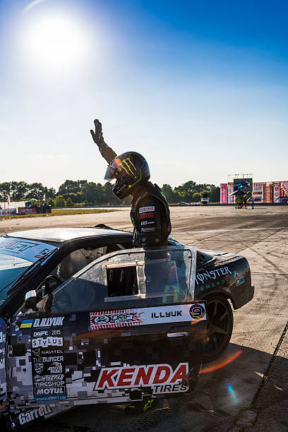 Racer Dmytro Illyuk welcomes visitors Vinnytsia,Ukraine-July 25, 2015:  Racer Dmytro Illyuk welcomes visitors near the track in the Drift championship of Ukraine on July 25,2015 in Vinnytsia, Ukraine. monster energy stock pictures, royalty-free photos & images