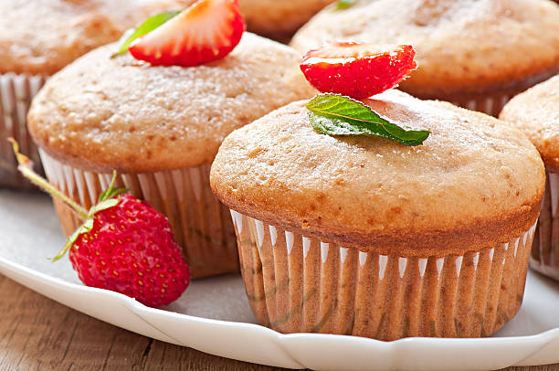 istock Strawberry muffin on a white plate with a fresh strawberry 497751849