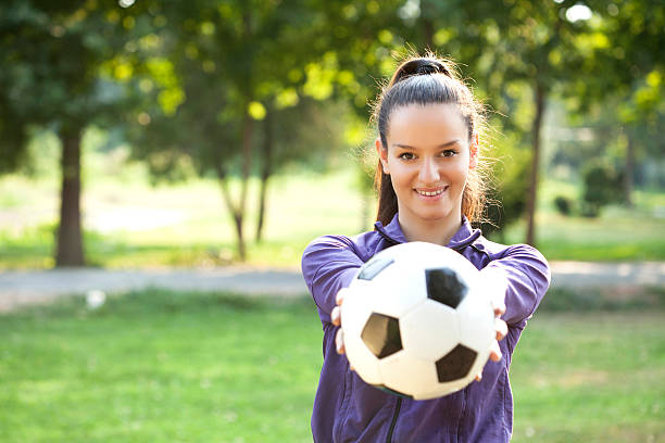 istock young woman with soccer ball 497754207