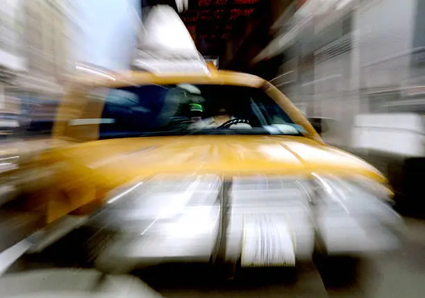 NYC taxicab in motion going through Times Square