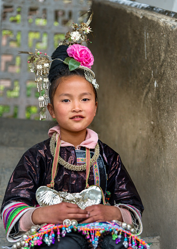 small Dong Village, Huang Gang,Child is dressed in traditional Dong clothing. 