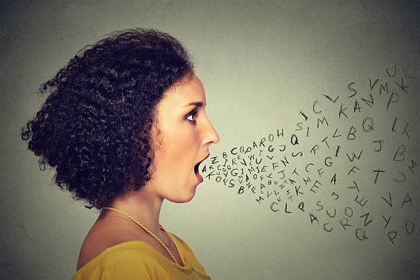 Woman talking with alphabet letters coming out of mouth Woman talking with alphabet letters coming out of her mouth. Communication, information, intelligence concept alphabetical order photos stock pictures, royalty-free photos & images