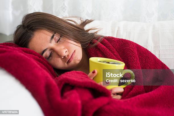 Ill Young Girl With Fever Drinking Cup Of Warm Tea Stock Photo - Download Image Now - 2015, Adult, Beautiful People