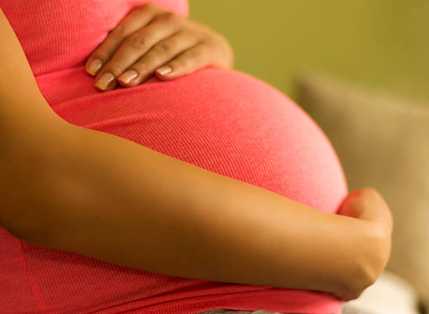 istock Pregnant woman embracing her belly 497783576
