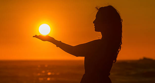 Happy Girl hold Sun silhouettes at sunset Asian Girl at Davenport beach of California. monterey bay stock pictures, royalty-free photos & images