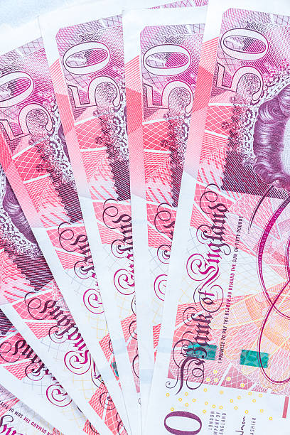 istock Fifty £50 pound sterling notes fanned out. 497785732