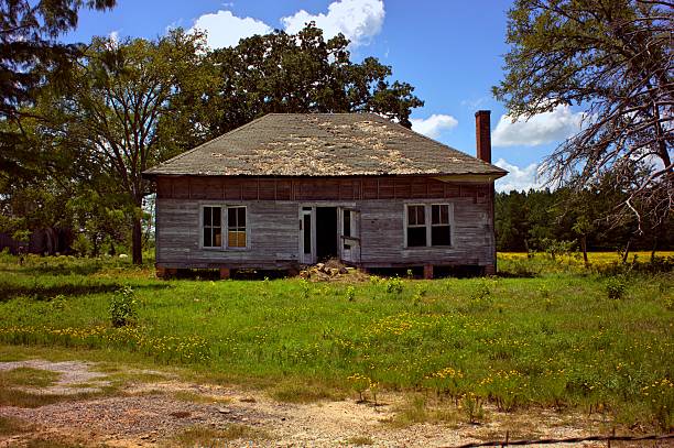 istock Abandoned House in Field with Trees,Blue Sky, and Clouds 497786242