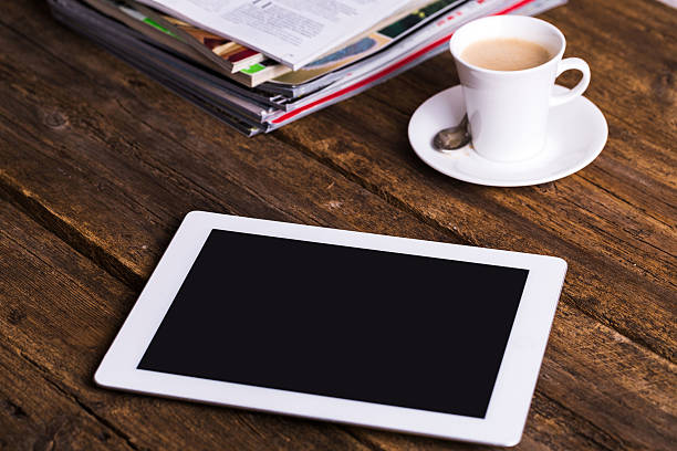 istock digital tablet and coffee on old wooden background 497786462