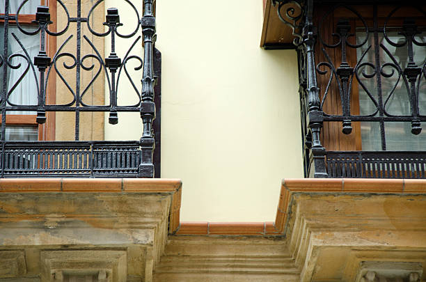 A original simple composition with black railing, building facade and sunlight