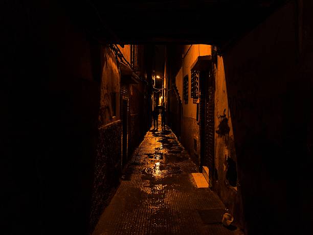 istock two silhouettes walking in a narrow street 497787142