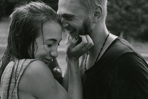 istock beautiful couple hugging in the rain 497789342