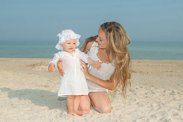 istock Mother and her daughter having fun on the beach 497789582