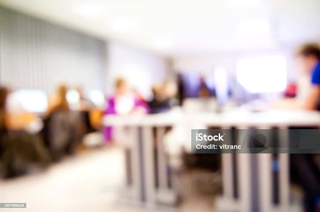 Front view of group of business people on computer seminar Front view of large group of business people in a computer lab using computers 2015 Stock Photo