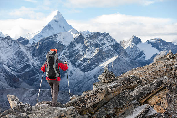 Hiker walks on train in Himalayas Hiker walks on train in Himalayas solu khumbu stock pictures, royalty-free photos & images