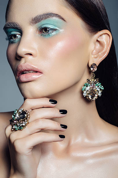 Elegant girl advertising jewelry Elegant girl advertising jewelry. Professional make-up. haute couture stock pictures, royalty-free photos & images