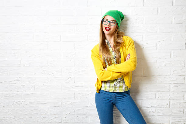 Street Style Hipster Girl at White Brick Wall Background stock photo