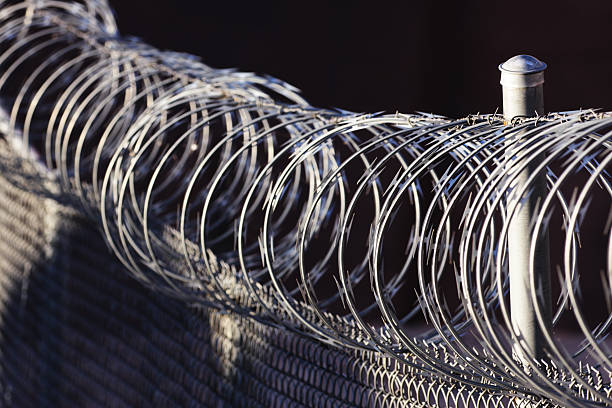istock Razor Wire Barbed Fence Barrier 497792464