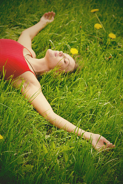 istock Beautiful woman lying on grass 497795023