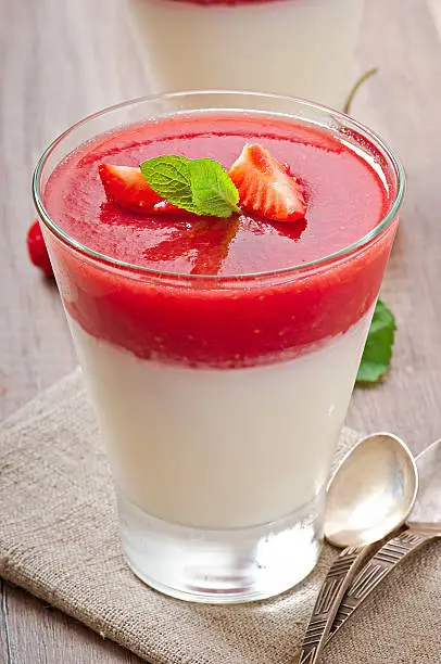 Dessert Panna Cotta with fresh strawberry on old wooden background