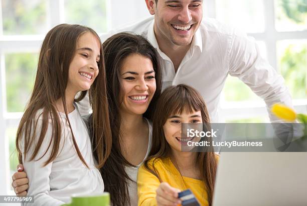 Happy Family Looking At Laptop Stock Photo - Download Image Now - Adult, Beautiful People, Beauty