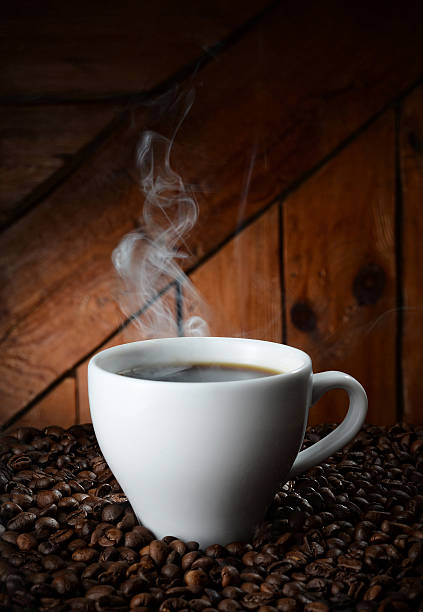 istock white cup on coffee beans on wooden background 497796057