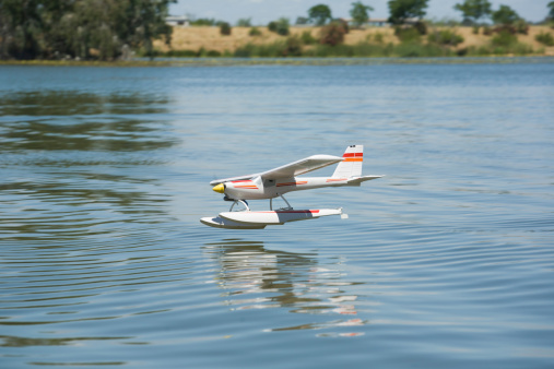 Radio controlled Hydroplane flying and sailing over the Guadiana river surface, Badajoz, Spain