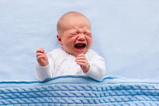 Photo of Newborn baby boy on a blue blanket