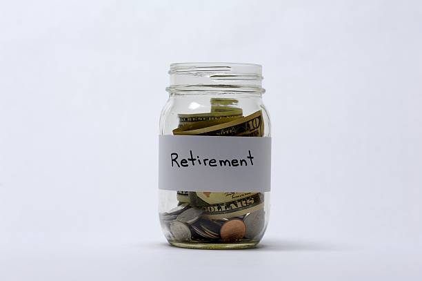 istock Retirement Savings Jar Of Coins And Banknotes 497801436