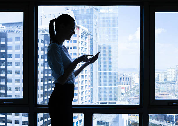 istock Woman using mobile smart phone in the office 497802534