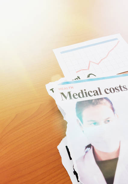 istock Newspaper article on medical costs with rising graph 497802660