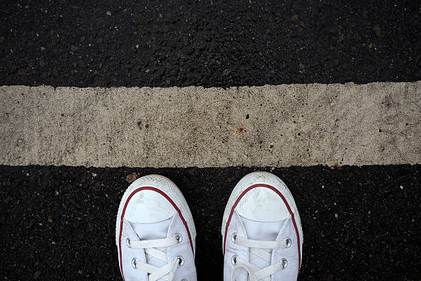 istock White sneaker shoes standing on street. 497804126