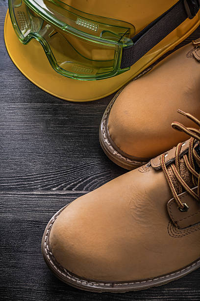 istock Protective spectacles hard hat safety boots on wooden board 497805030