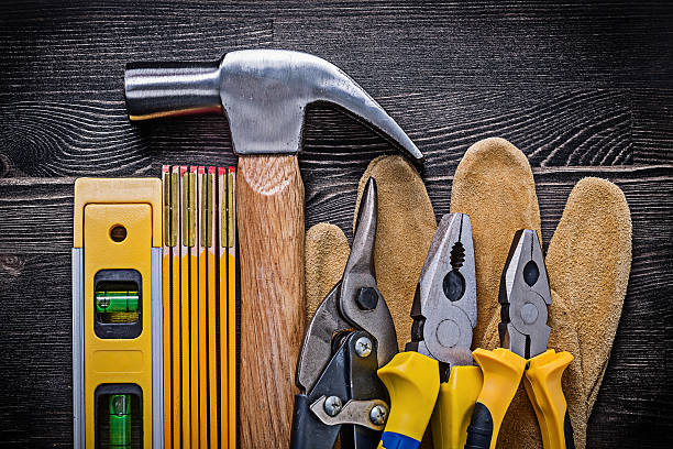 istock Safety gloves pliers wire cutter wooden meter construction level 497805100