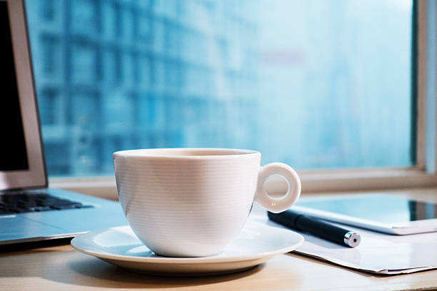 Laptop and a cup of coffee on office desk