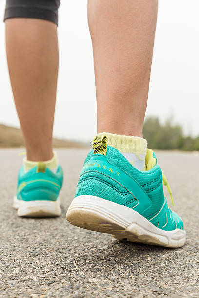 istock Runner feet running on road closeup on foot 497806356