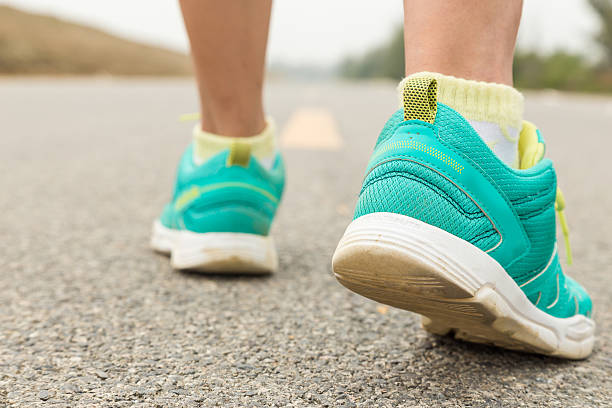 istock Runner feet running on road closeup on foot 497806398