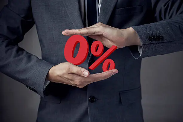 Photo of Business man Presenting Zero Percent, indicating zero interest a