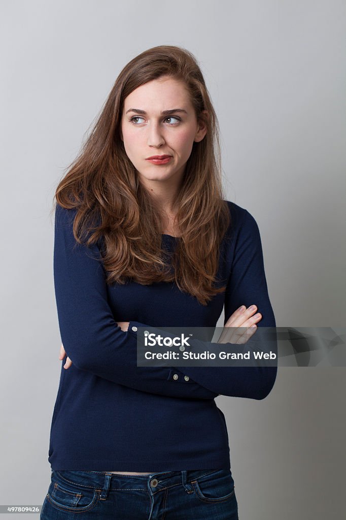 portrait of offended beautiful girl expressing disagreement and reflection doubt and worry concept - pouting 20s woman with long brown hair disliking with displeased body language,studio shot Arguing Stock Photo