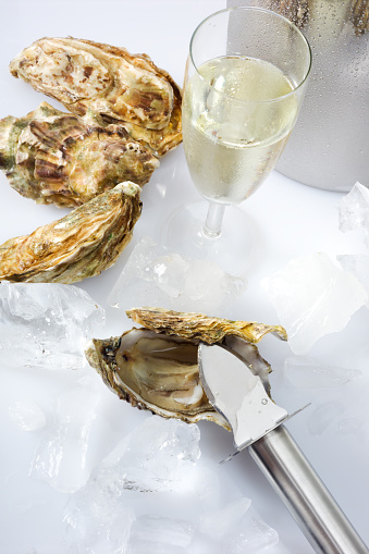 Oyster and knife, ice, champagne glass